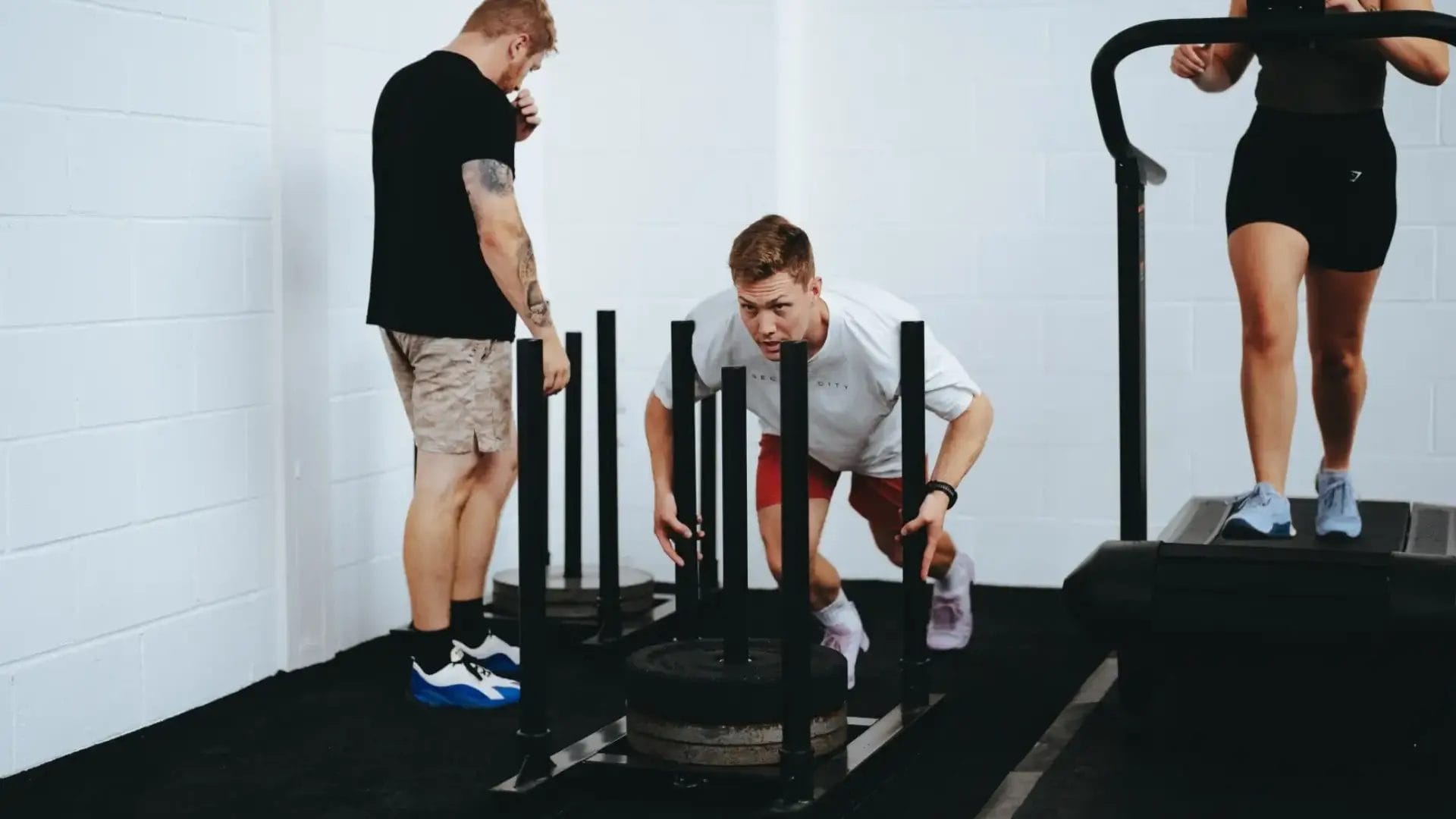 man pushing sled